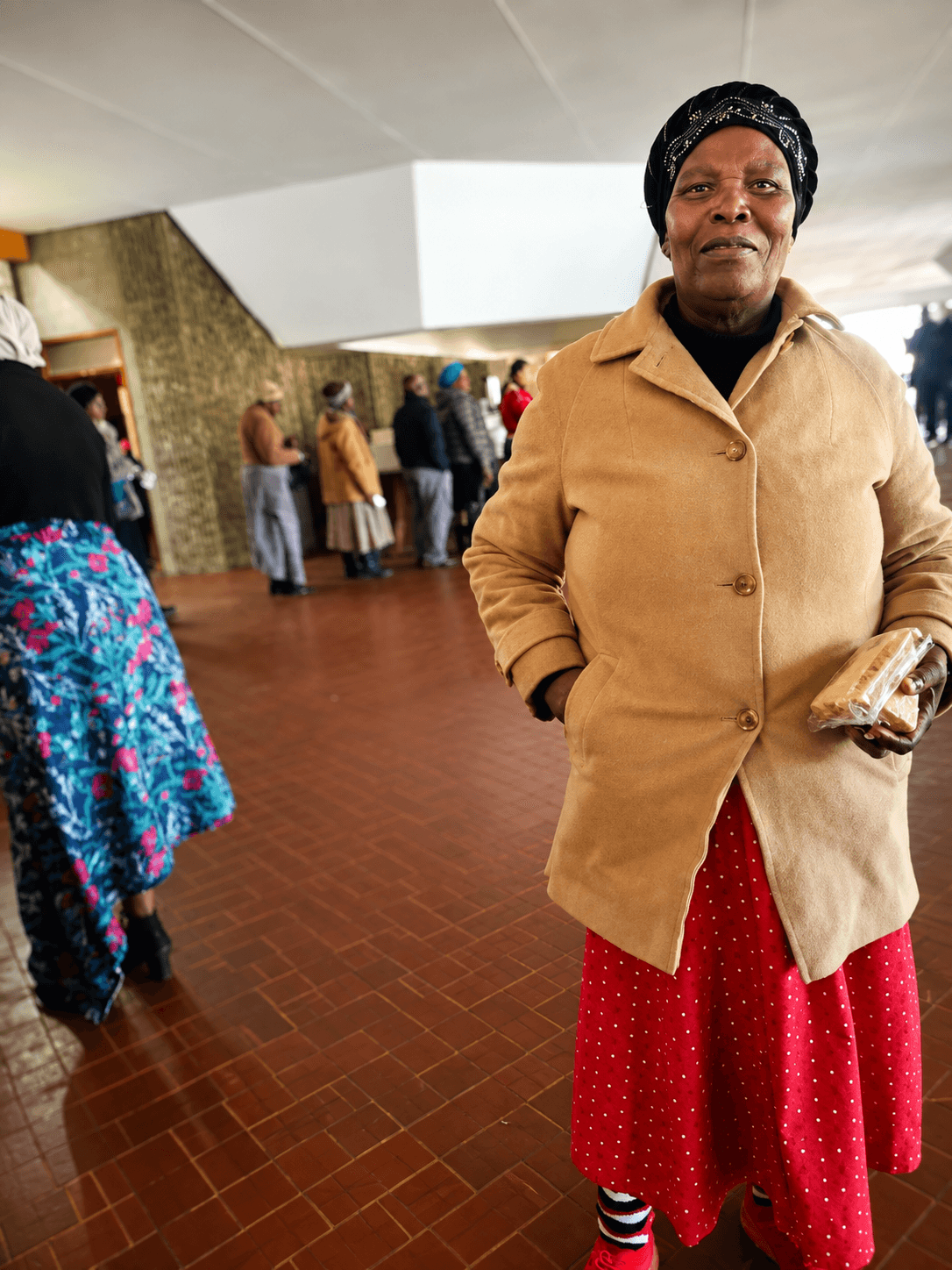 A club member holding a packed lunch at a community gathering